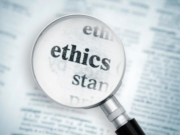 Magnifying glass highlighting the word ethics