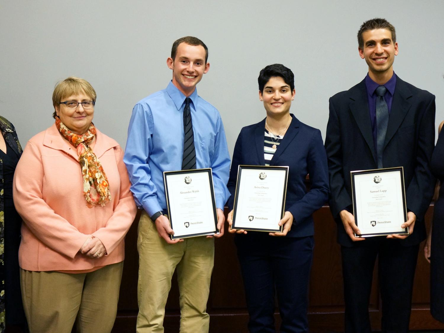 Three administrators and three students stand after earning prize money for undergraduate thesis award