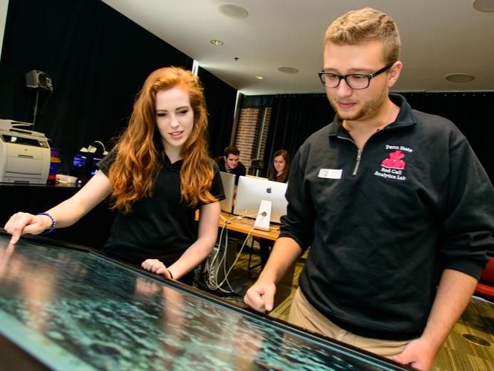 Two Penn State students work in the Extreme Events Lab.