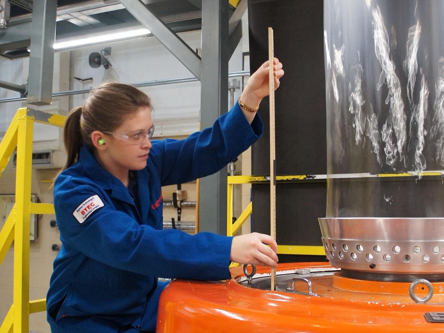 student measures frost line of blown film