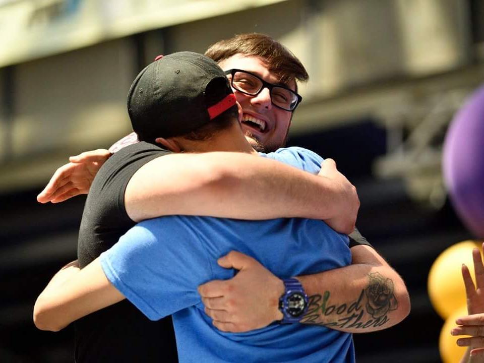 Penn State Behrend senior Billy Santoro hugs a boy to whom he has donated bone marrow.