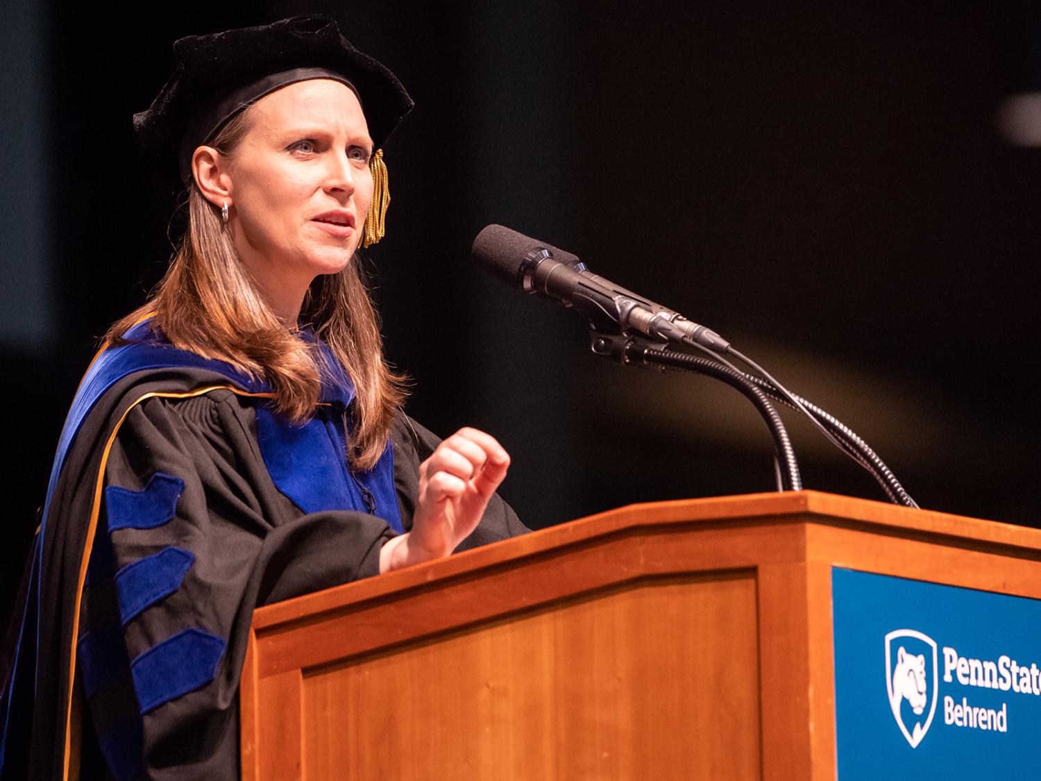 Dr. Alicyn Rhoades at commencement podium