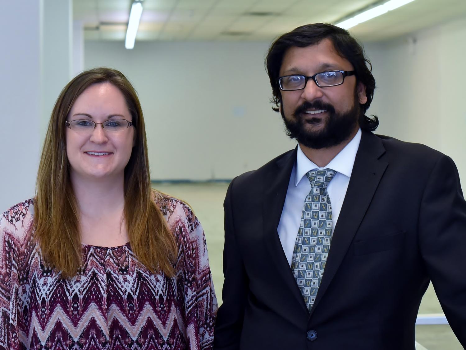 The co-owners of the Oasis Market pose for a portrait in the market