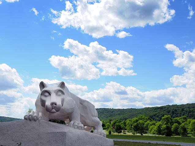 Penn Statte Lehigh Valley Lion Shrine statue with mountain and blue sky behind it.