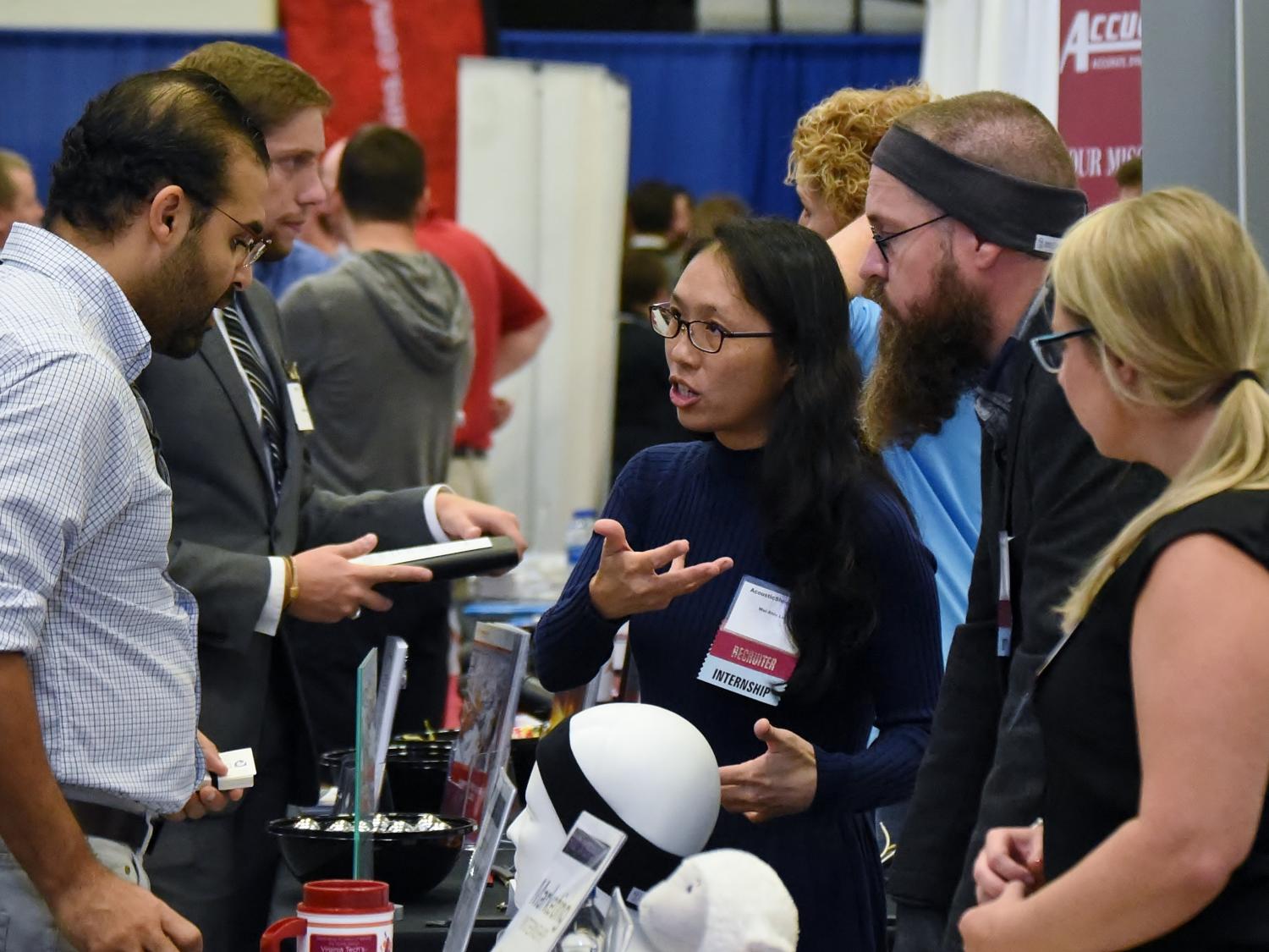 AcousticSheep LLC CEO Wei-Shin Lai, center, meets with a student during Penn State Behrend's Fall Career and Internship Fair, held Sept. 19 at the college.