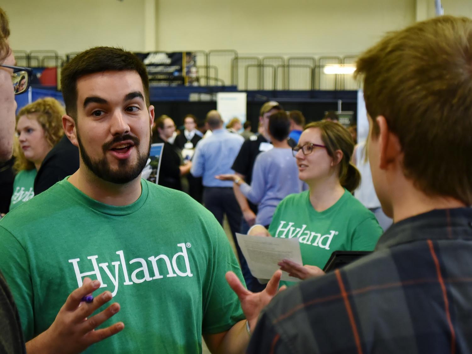 Tyler Conn, a Developer 2 for Hyland, meets with students at Penn State Behrend's Fall Career and Internship Fair.
