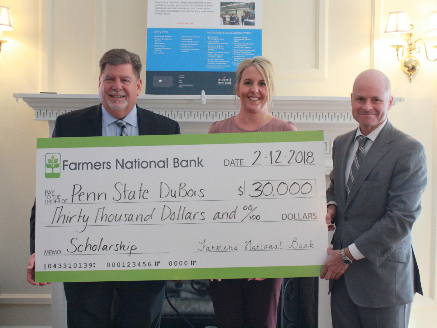 Chancellor M. Scott McBride accepts a check for the establishment of an Open Doors Scholarship from Farmers National Bank 