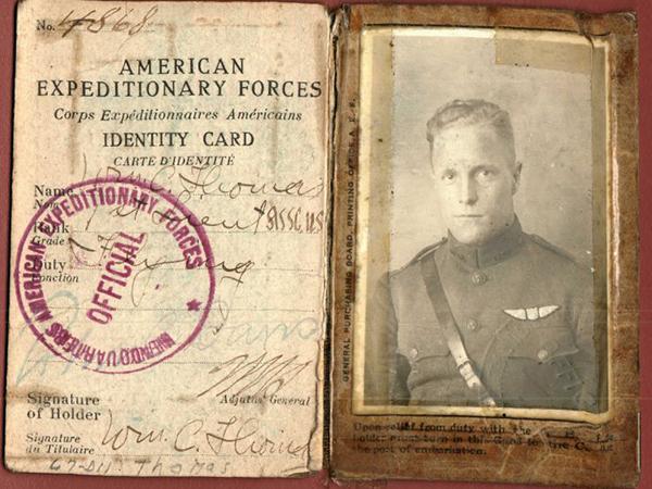 old black and white image of a man in uniform and an old document