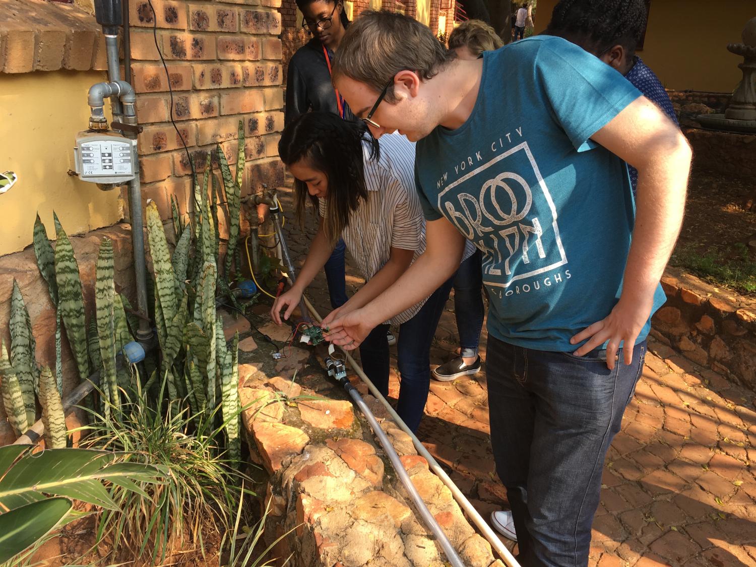 Students reviewing irrigation system in South Africa