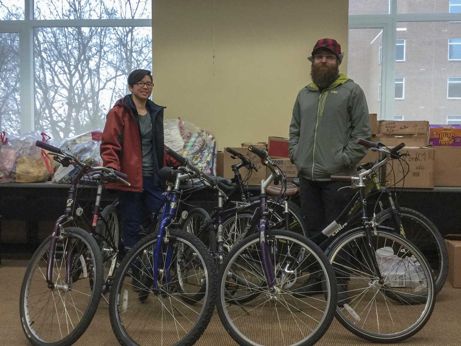 Individuals pose with bikes