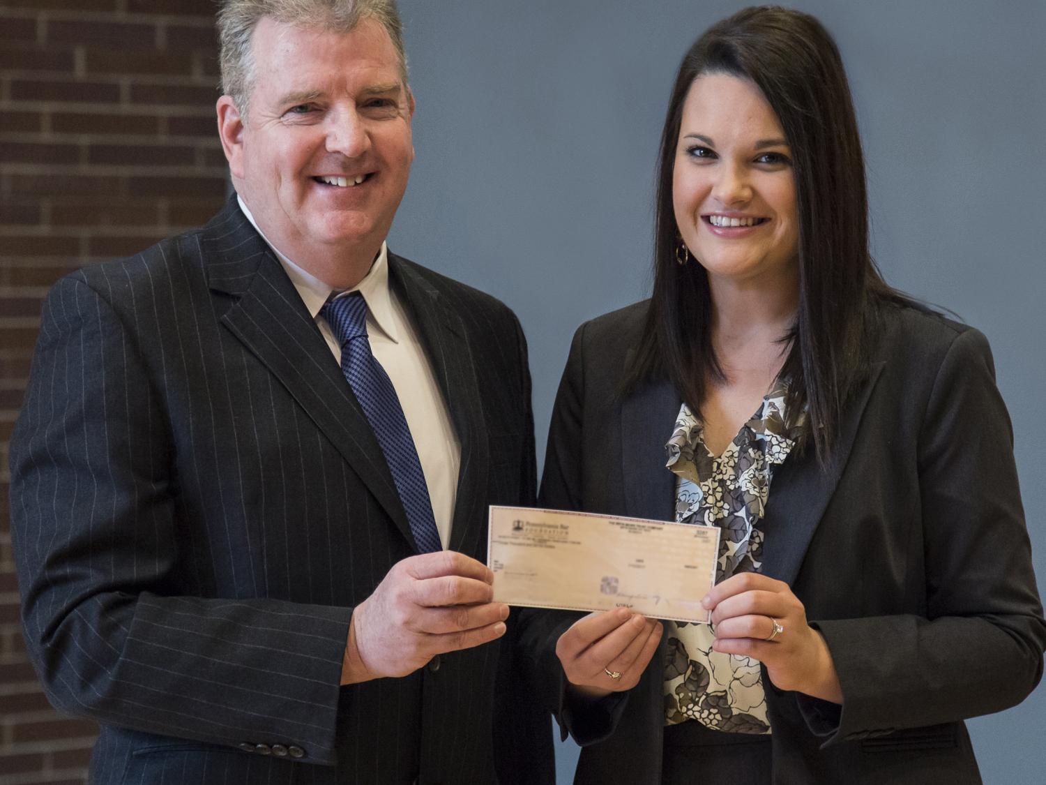 Michael J. McDonald, Esq. ’79 presents the Joseph T. McDonald Memorial Scholarship to third-year law student Francesca Kester who plans to begin a federal judicial clerkship in the Middle District of Pennsylvania after graduating this May. 