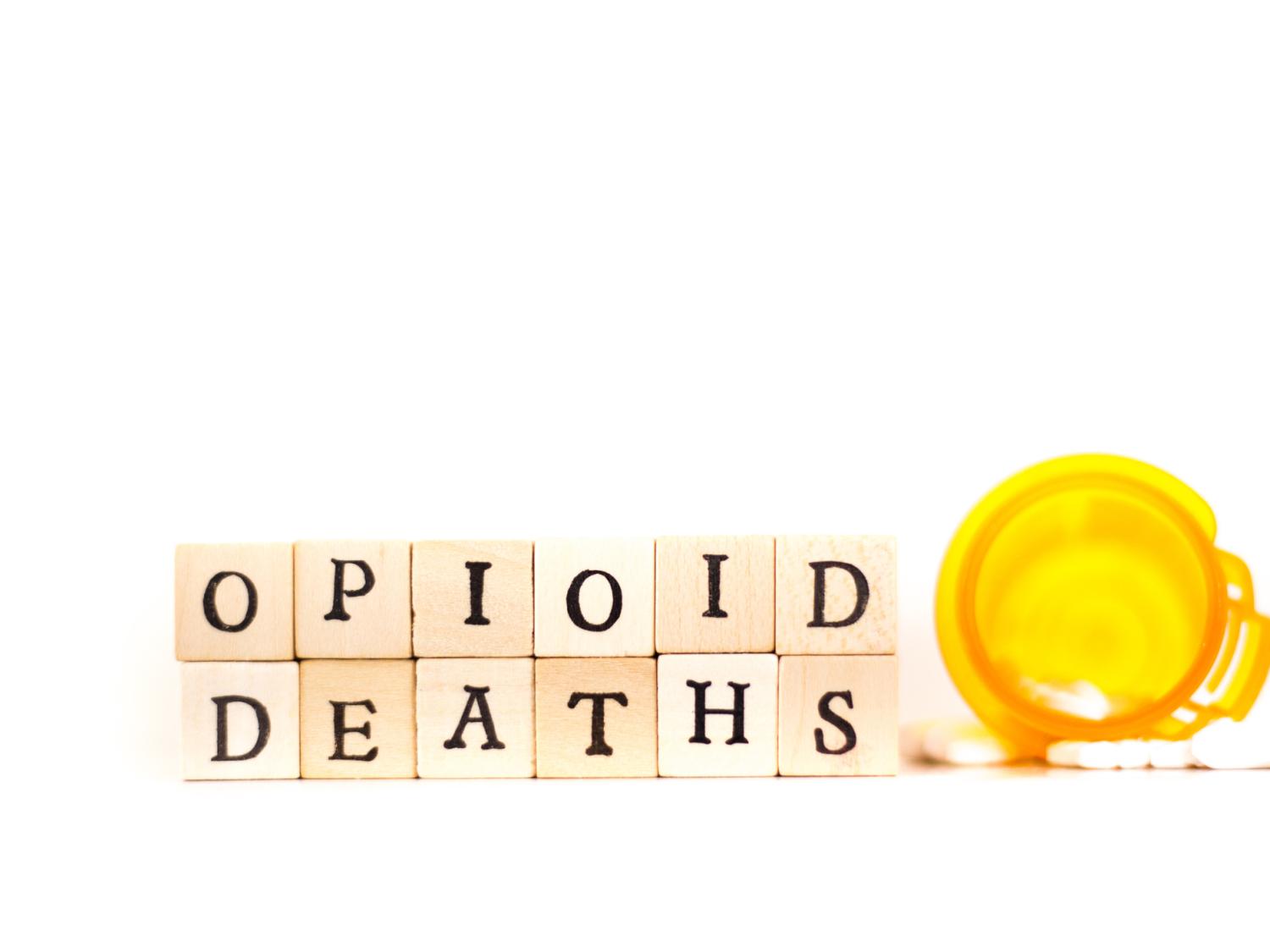 The words "Opioid deaths" written in wooden tiles