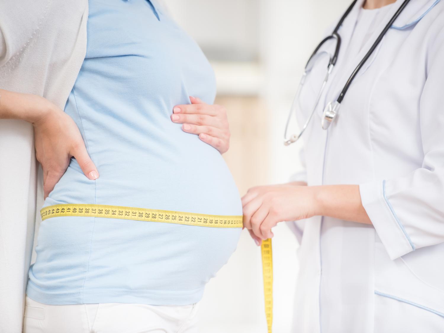 Pregnant woman with doctor