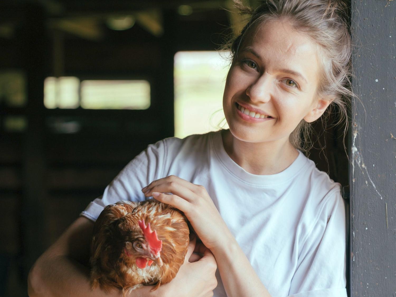 Girl holding a chicken