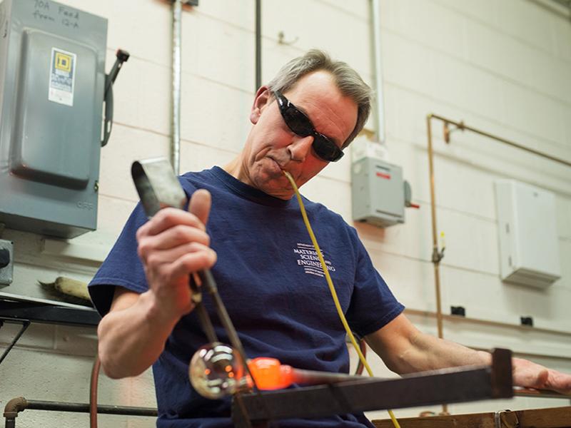Distinguished Professor of Materials Science and Engineering Carlo Pantano shapes glass at his glass blowing studio in the Hosler Building.