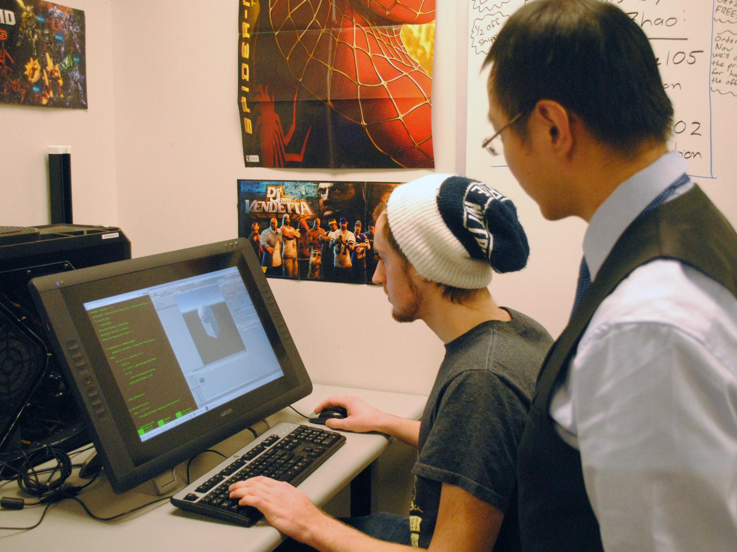 Senior computer science major Peter Kalmar works on the beginning stages of The Rush while Richard Zhao, lecturer in computer science and software engineering, looks on. 