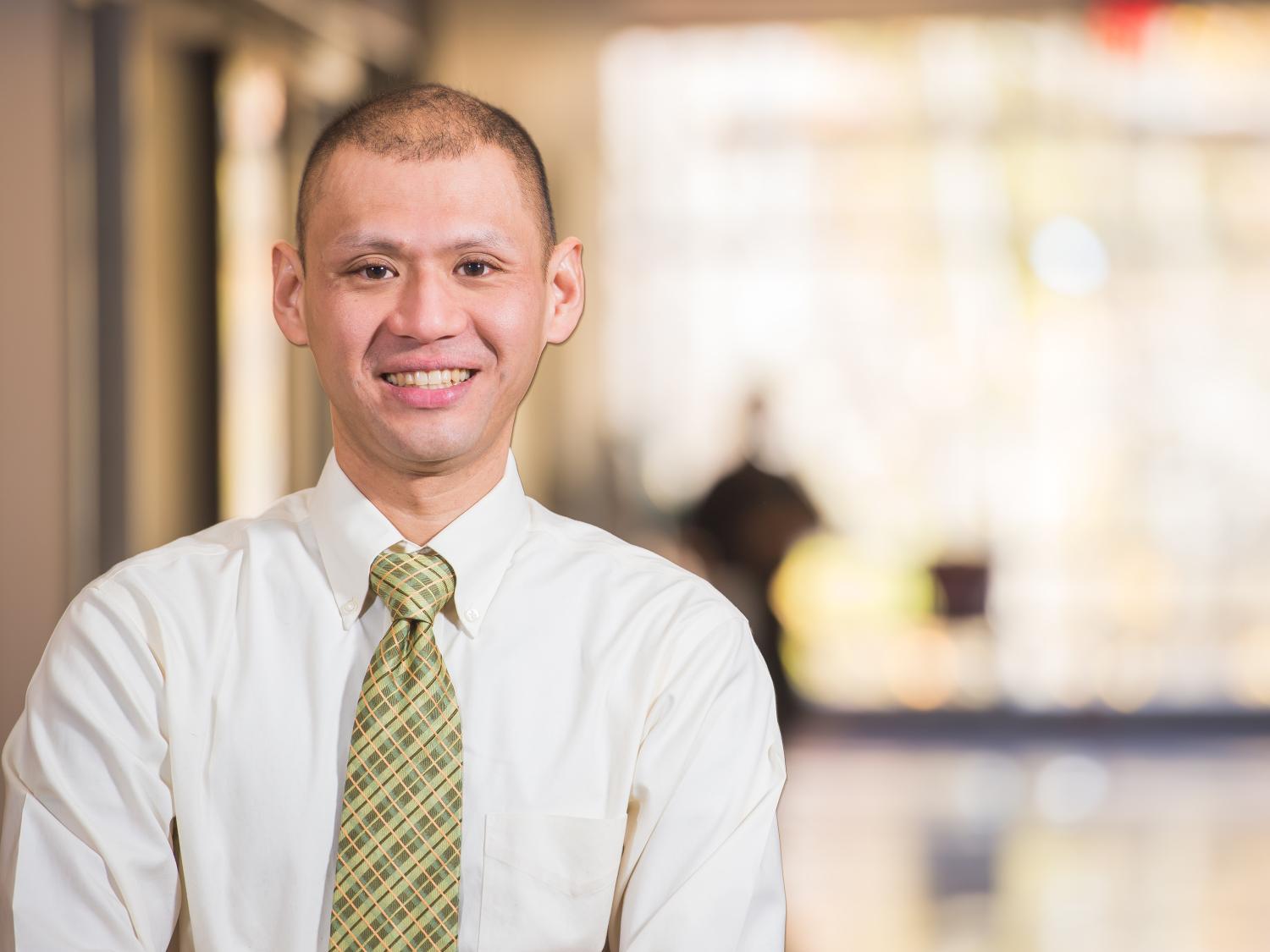A Penn State Behrend faculty member poses in a hallway.
