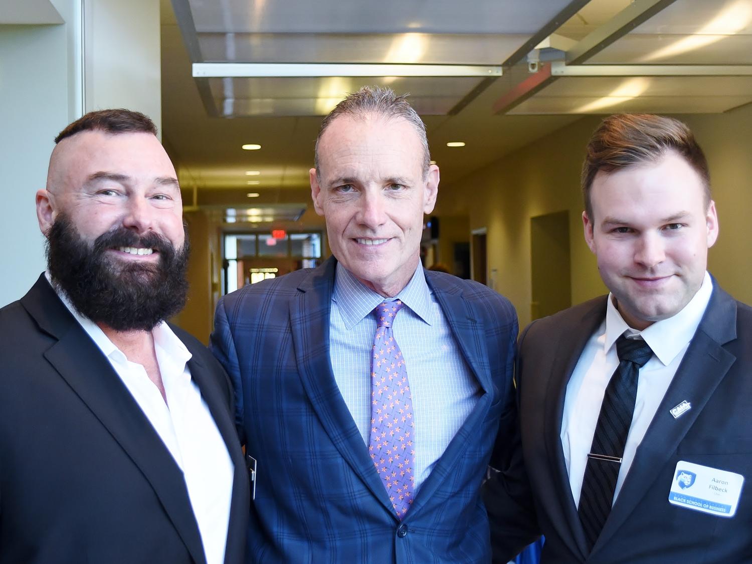 Greg Filbeck, William Kelly and Aaron Filbeck pose for a photo at the Finance Day program at Penn State Behrend's Burke Center.