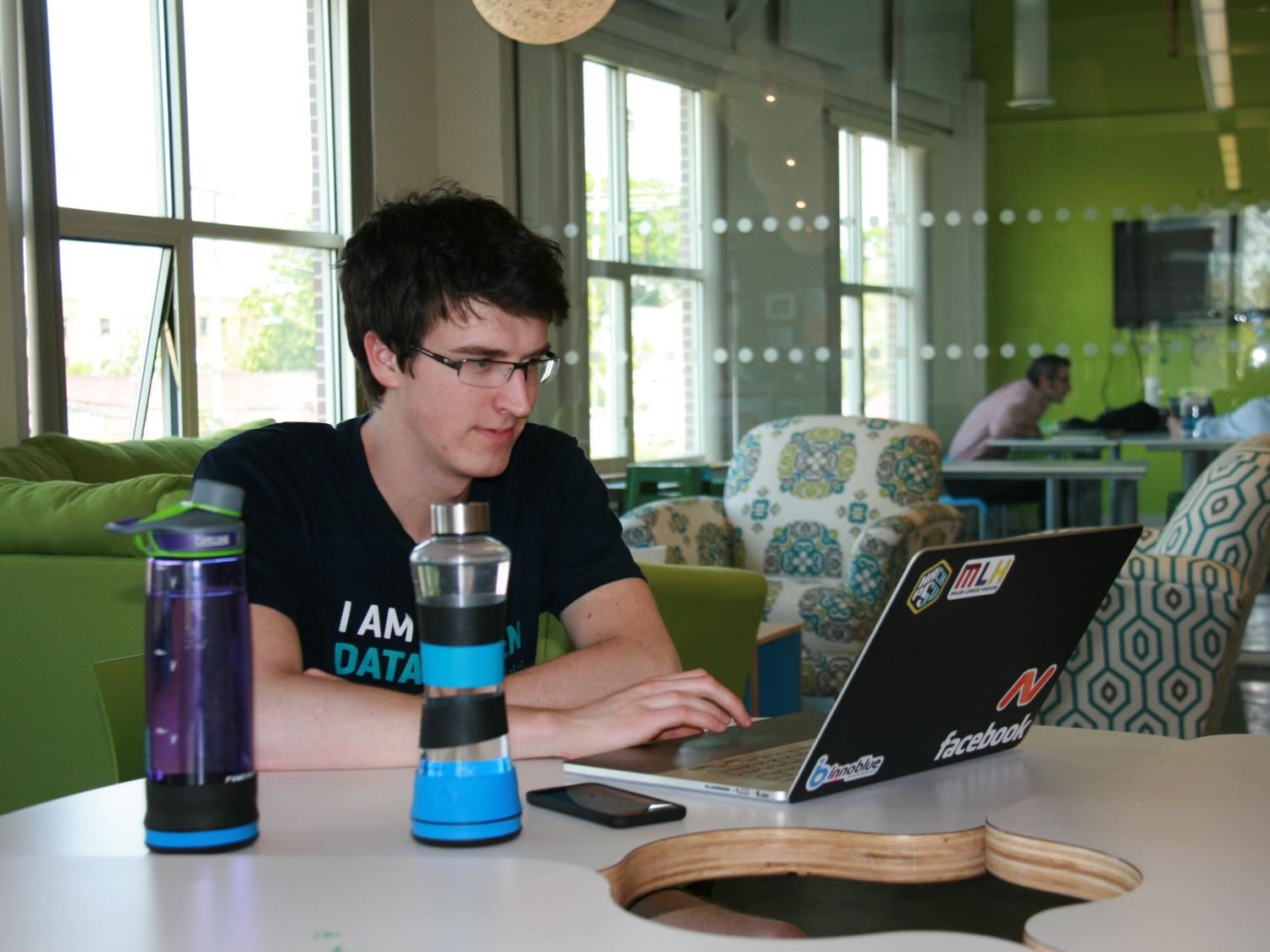 Matej Marjanovich, a Penn State junior in majoring in electrical engineering and co-founder of H2O-Pal, works on pre-order shipments while stay hydrated with his own product.