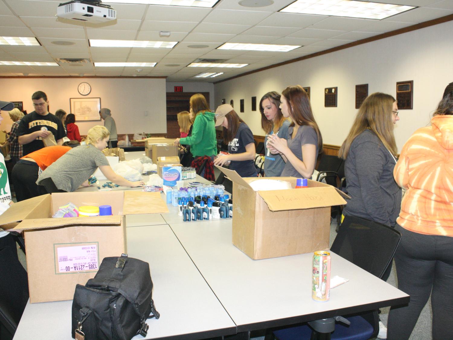 Students work to assemble Thanksgiving care packages. 