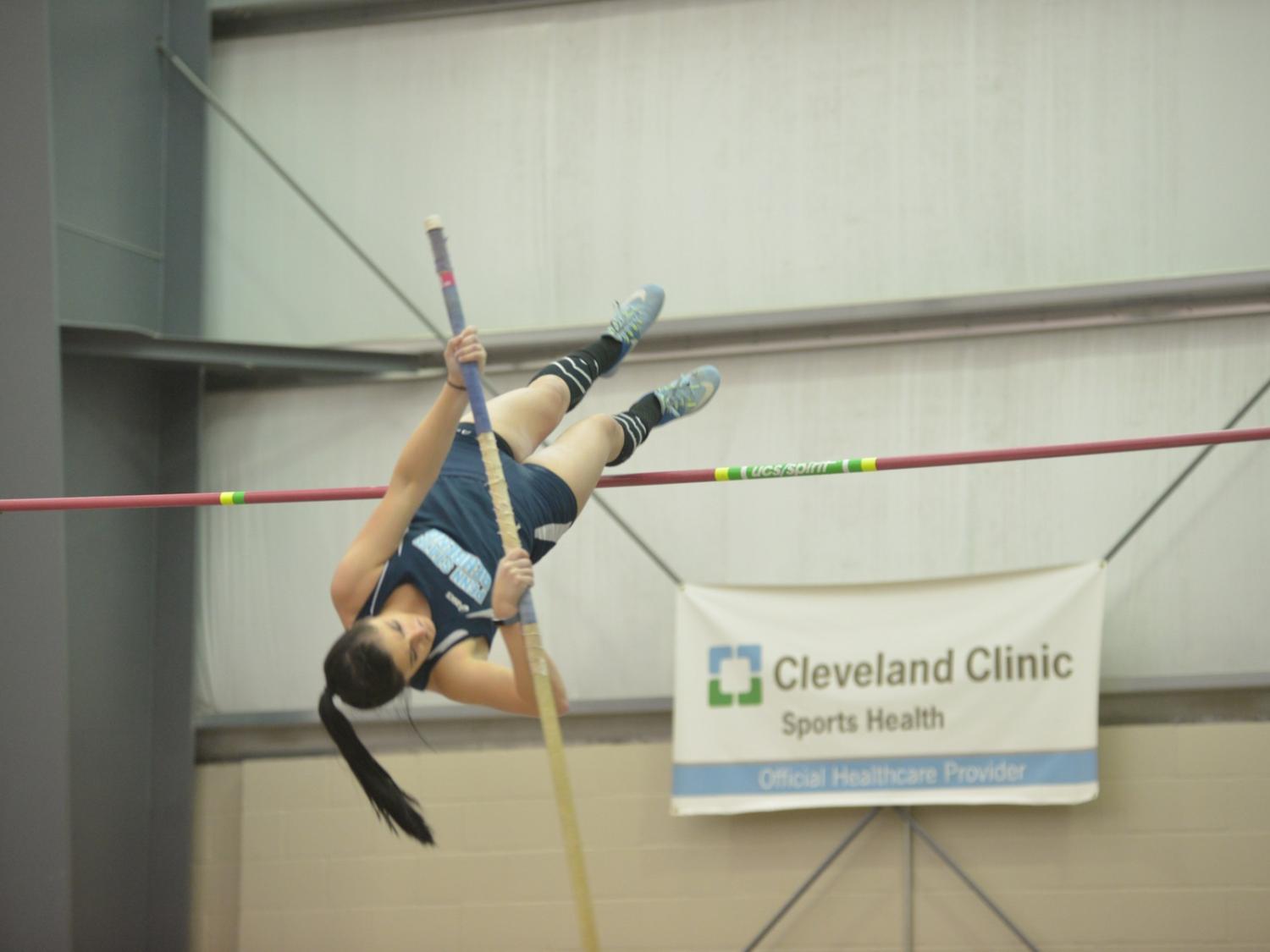 A Penn State Behrend student-athlete competes in the pole vault event.