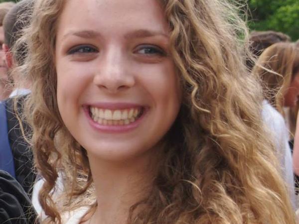 Hannah Pohlmann stands smiling, looking away from the camera