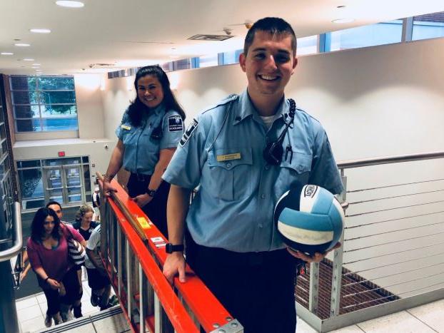 Student auxiliary officers retrieve volleyball