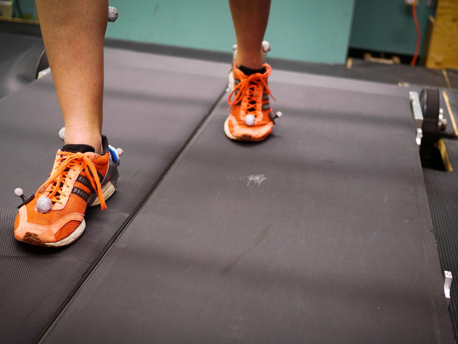 A subject walks on the dual-belt treadmill in the Biomechanics Lab