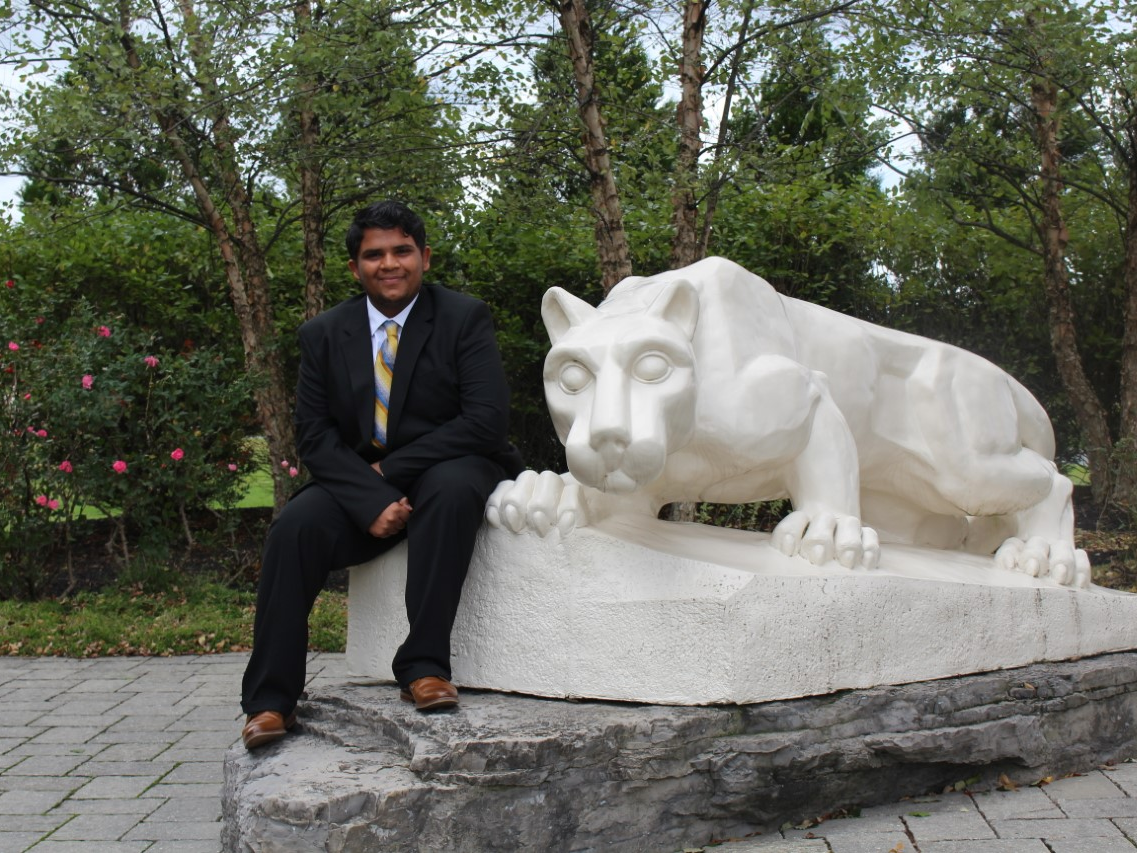 Hemil Patel in front of lion statue