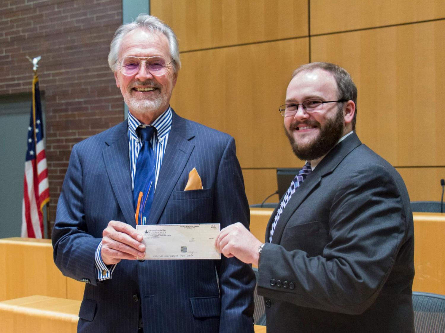 Attorney William F. Hoffmeyer presents the Louise Hoffmeyer-Overmiller Scholarship to 3L Christopher Harris
