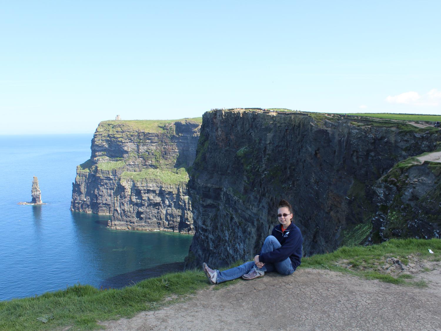 Student sitting on Ireland cliffs