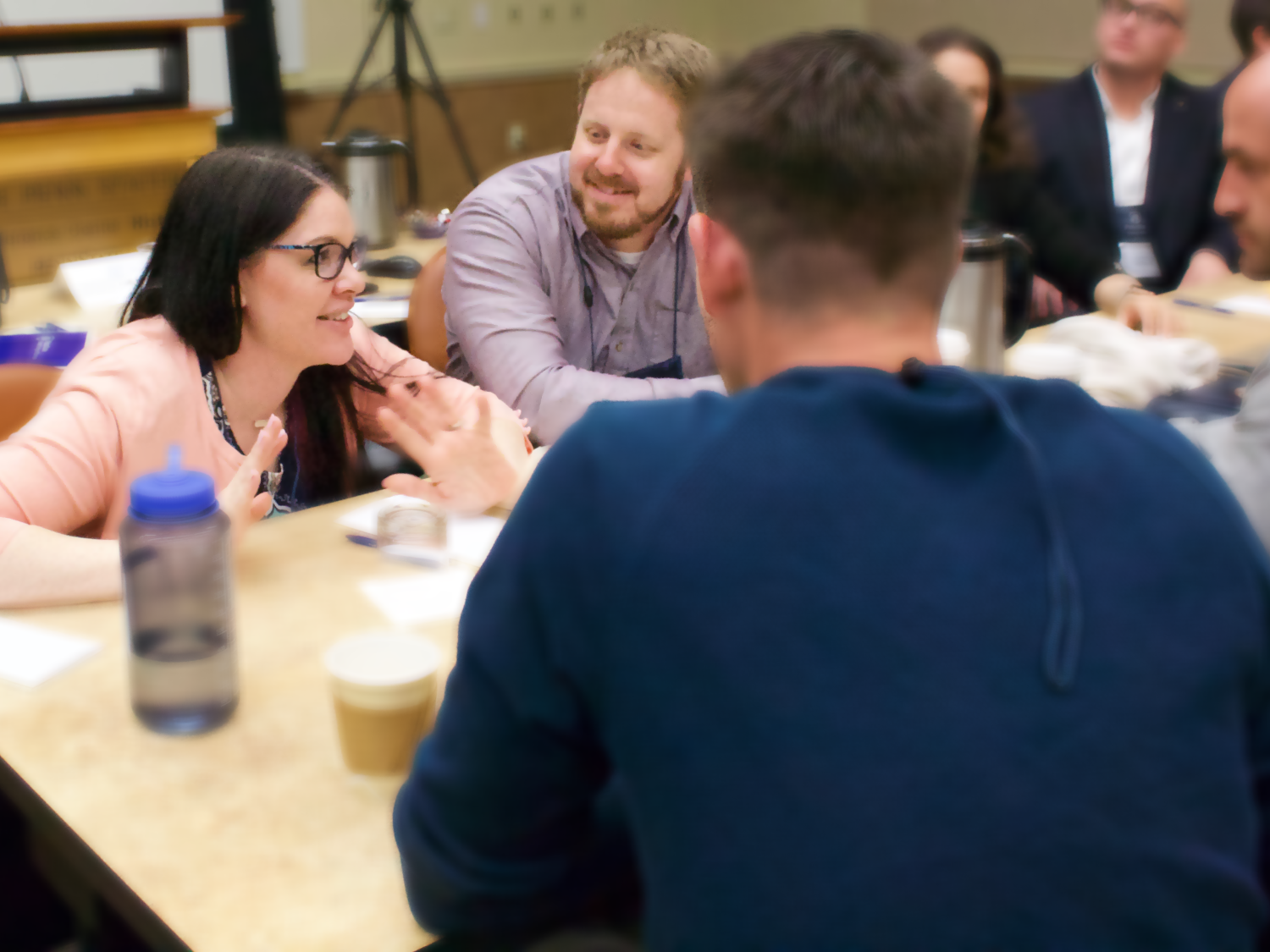 Cheryl Horten sits at a table with students enrolled in the Penn State Online MBA Program. 