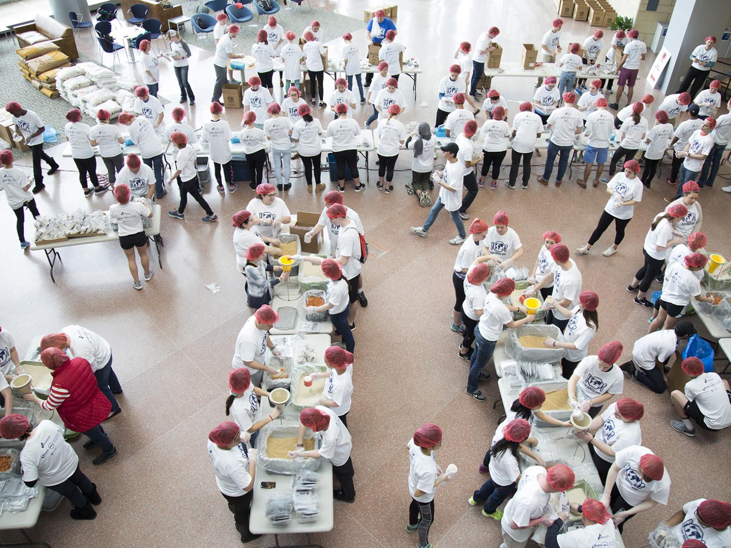 Students help package food aid packages.
