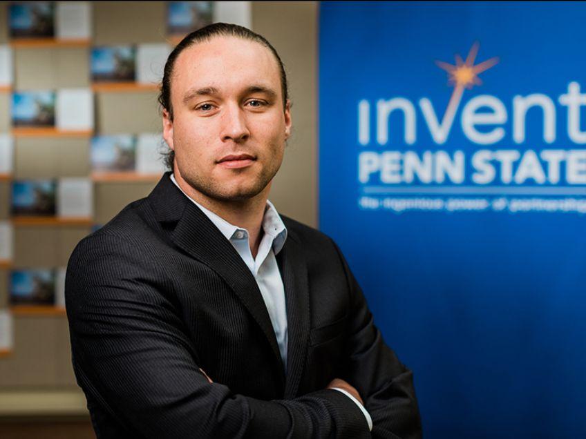 Headshot of Hunter Swisher in front of Invent Penn State sign