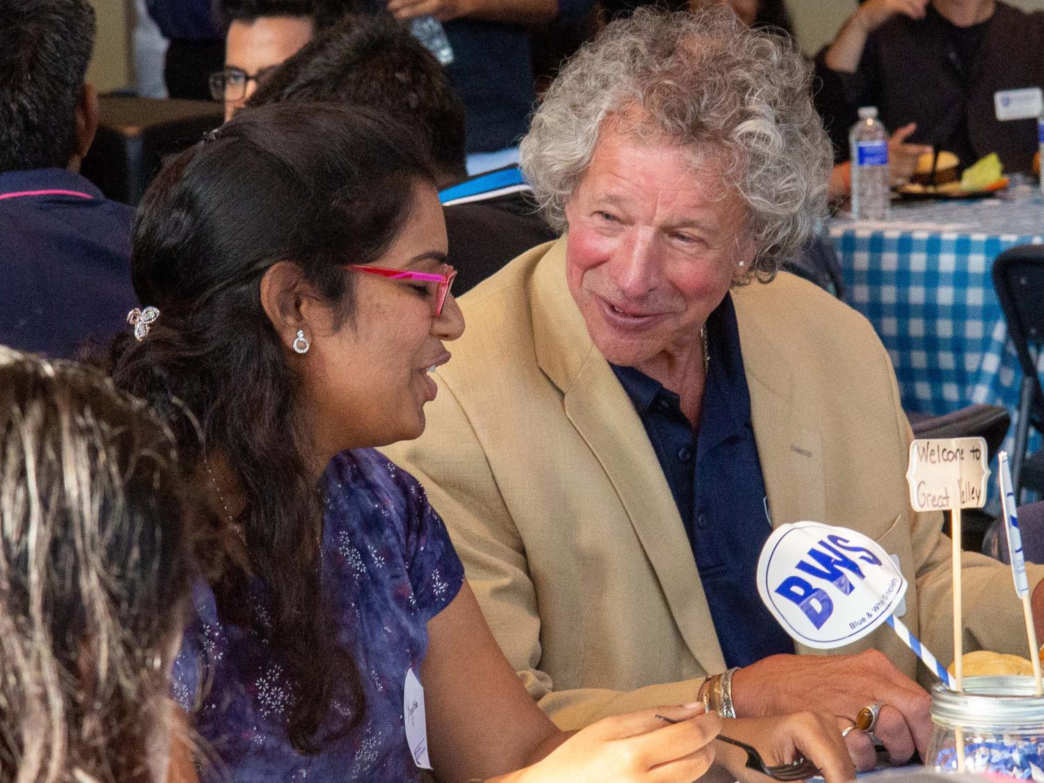 James Nemes talks with a student at the August 2019 international students BBQ