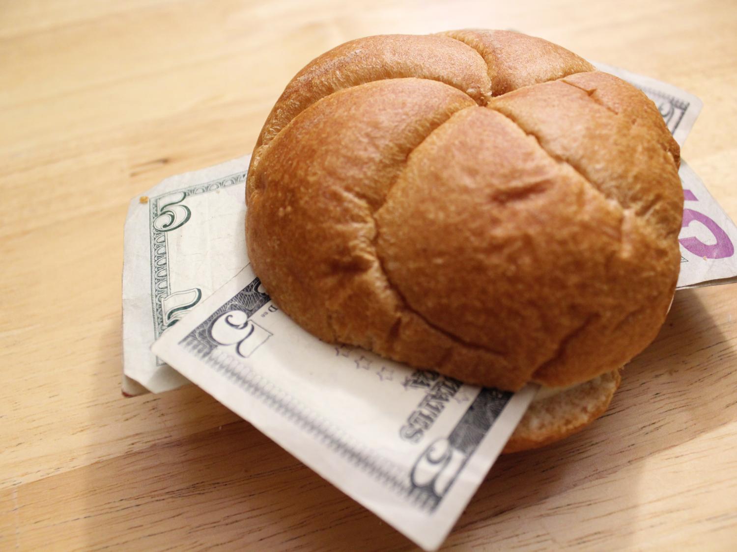 five dollar bills on a sandwhich roll