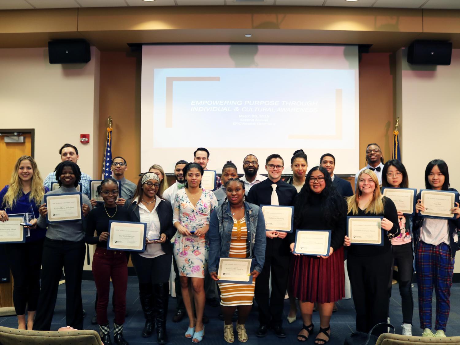 Group of Students standing holding award 