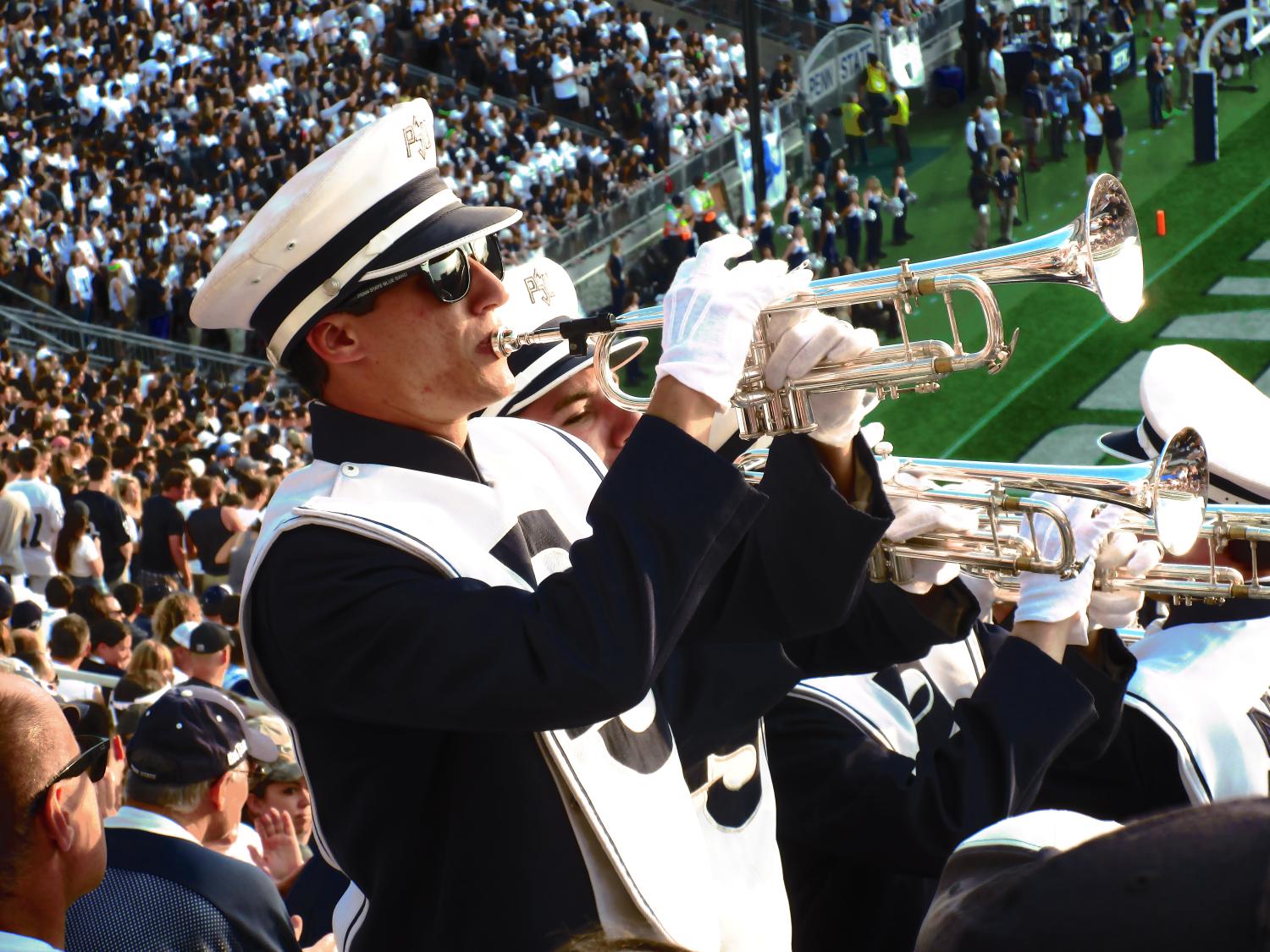 Greg Zuber playing the trumpet in the Blue Band during a home football game at Beaver Stadium.