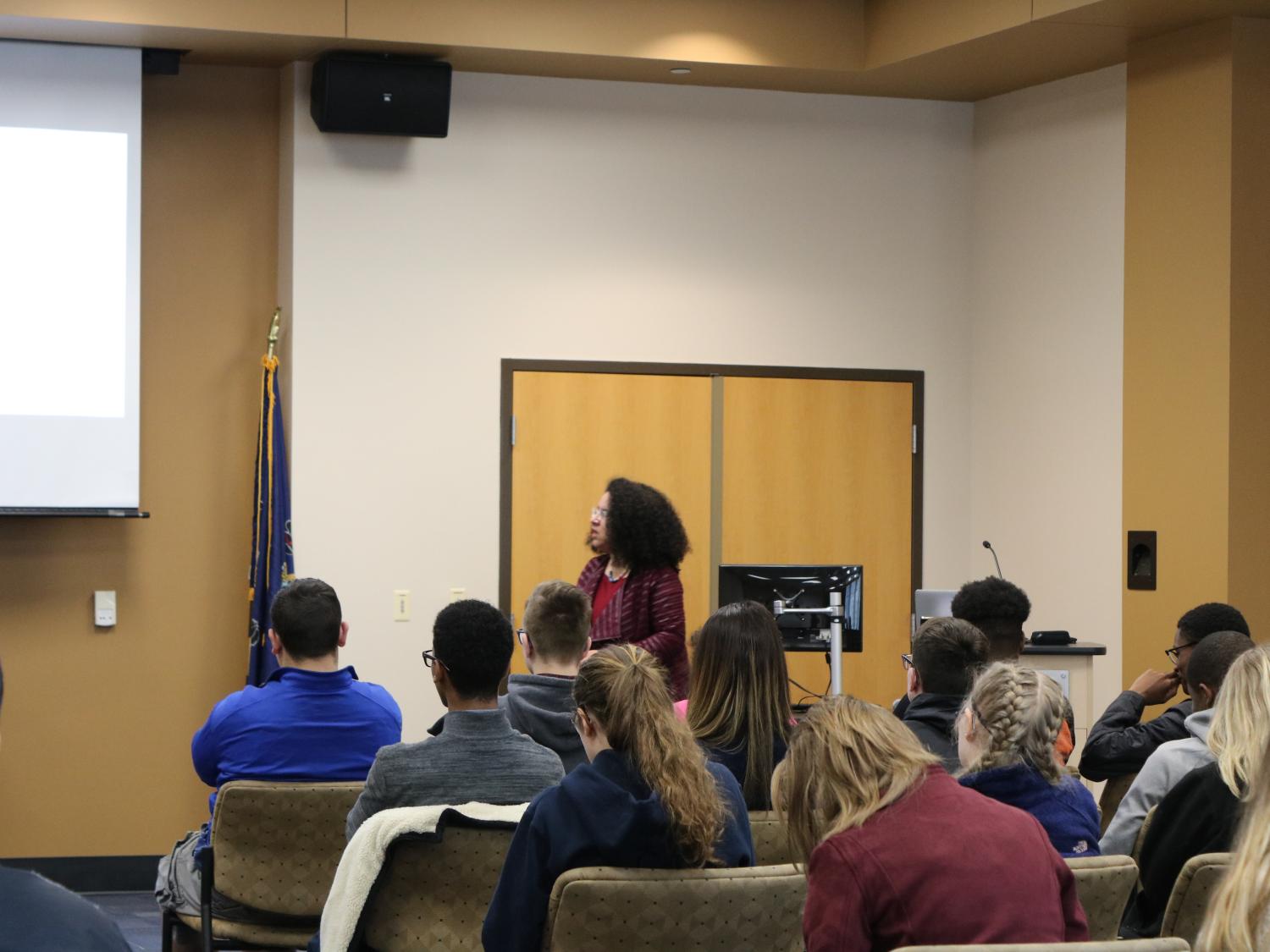 Classroom full of students looking at professor 