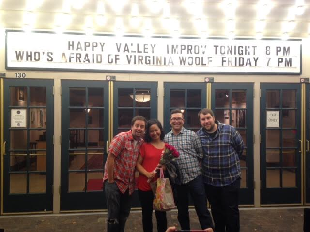 A picture of the four members of Happy Valley Improv in front of the State Theatre