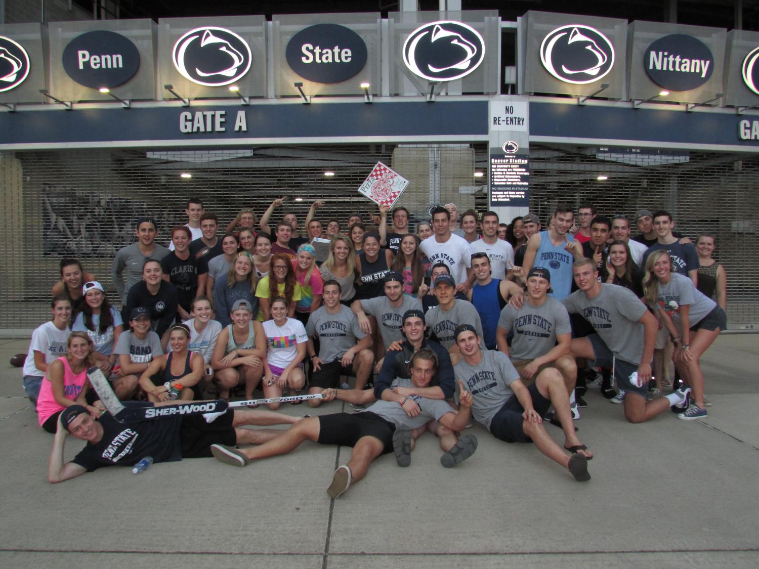 Group photo with Nittanyville campers and men's ice hockey