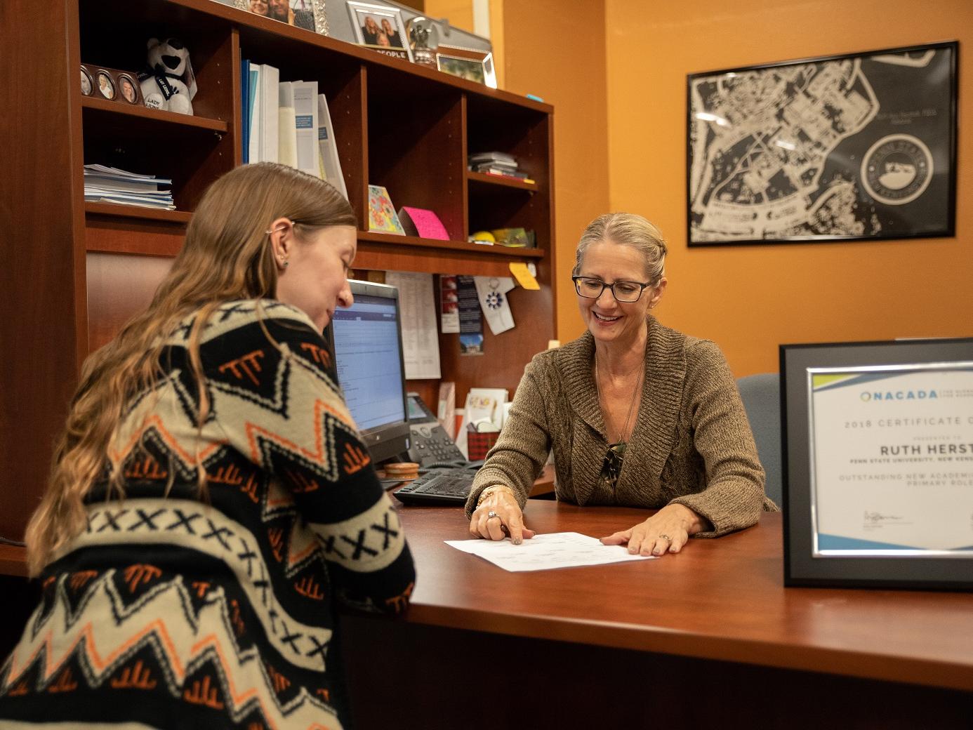 Ruth Herstek advises student