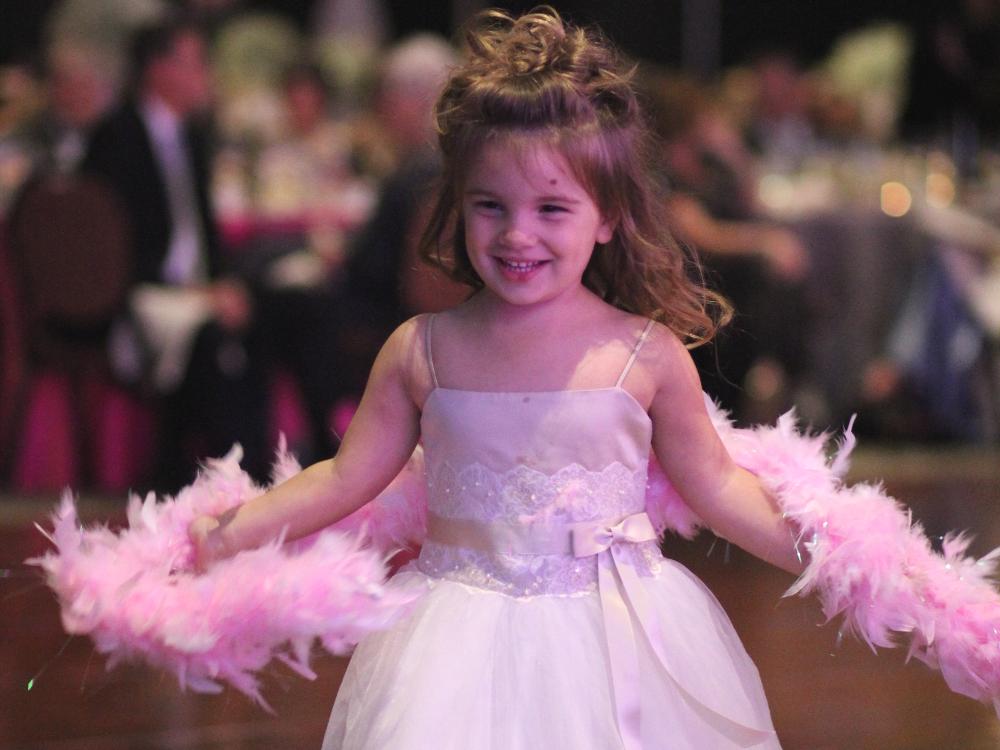 Leah Myers wears a dress and smiles while dancing.