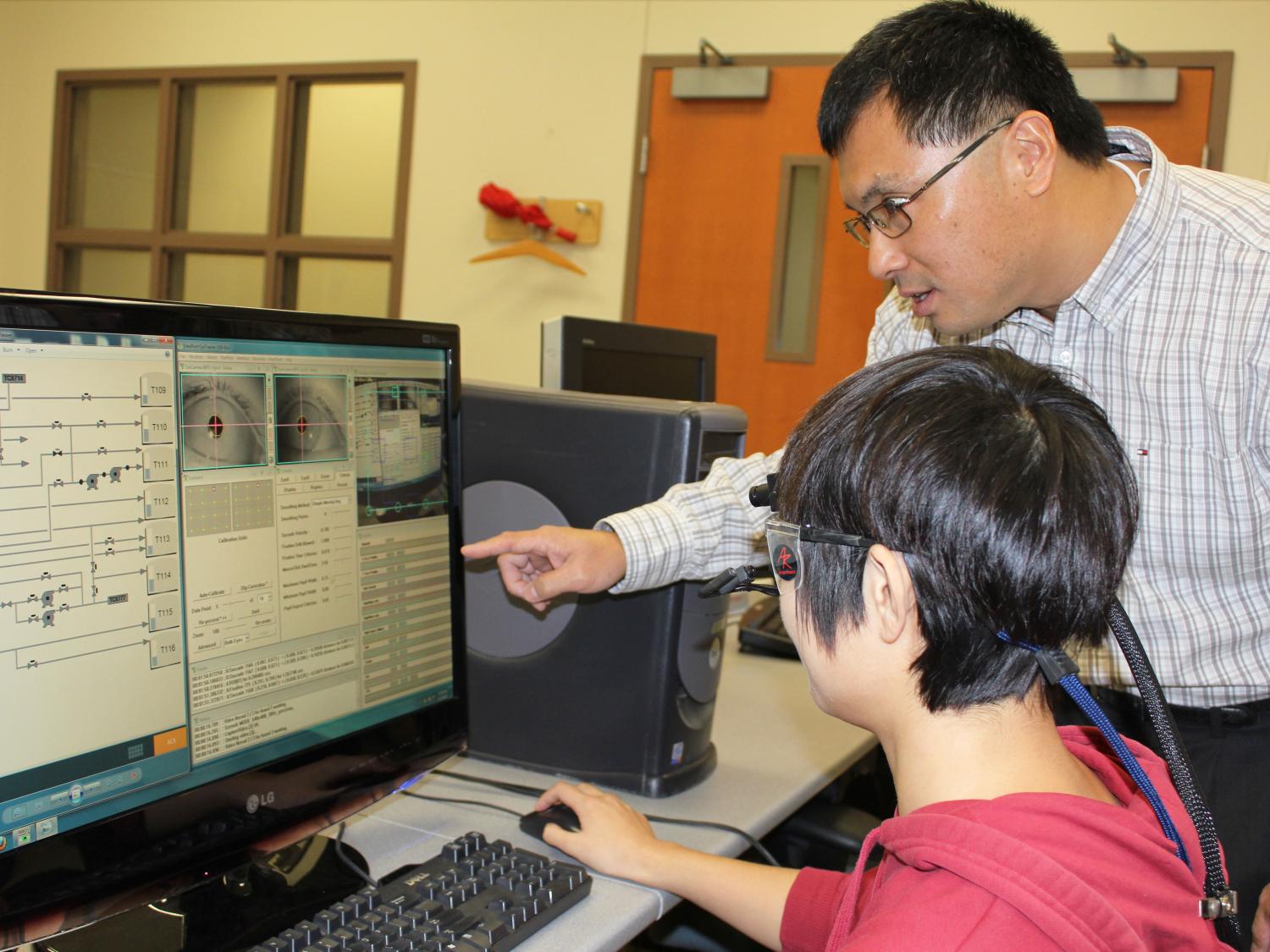 Ling Rothrock prepares the eye tracker for assessing a Piping and Instrumentation Diagram with Jingwen Li, a graduate student in industrial engineering.