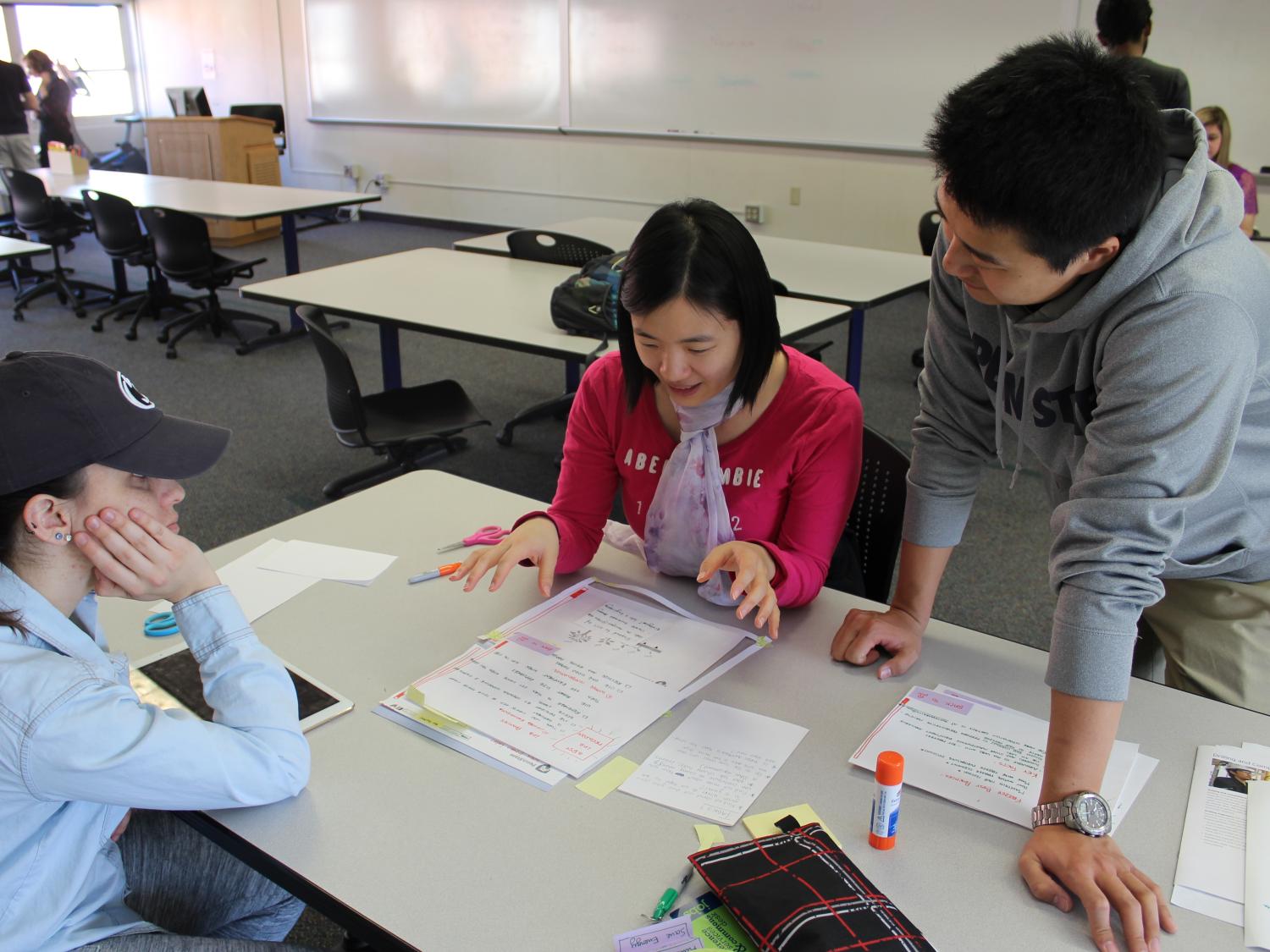 Maria Alessandra Nusiner and Jian Chen test their website design and usability during the low fidelity prototyping step of the design process. 