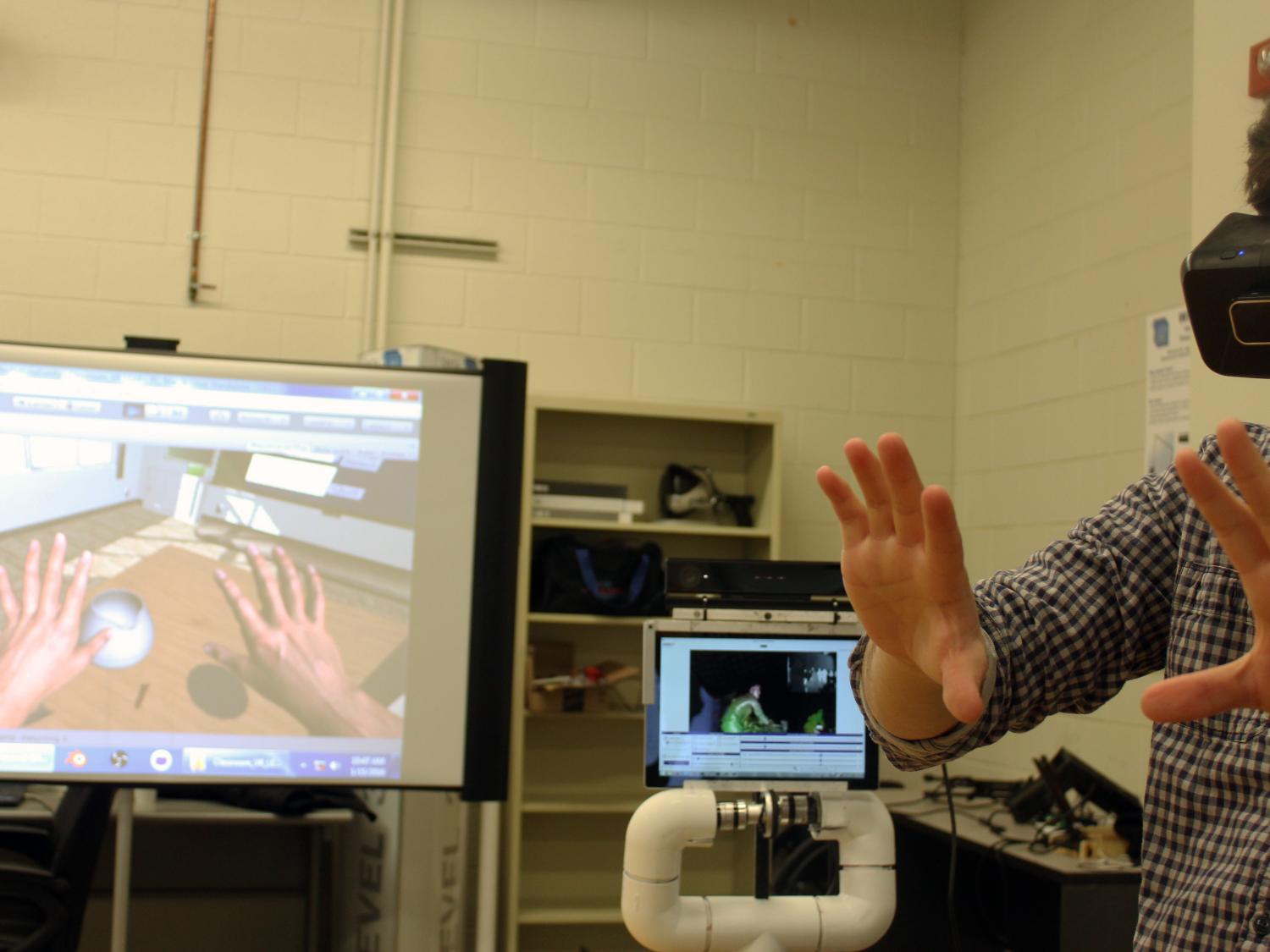 Owen Shartle (senior, computer science and engineering) views a digital version of his hands in the immersive virtual reality classroom environment designed in the Data Analysis Technology Advancement Lab.