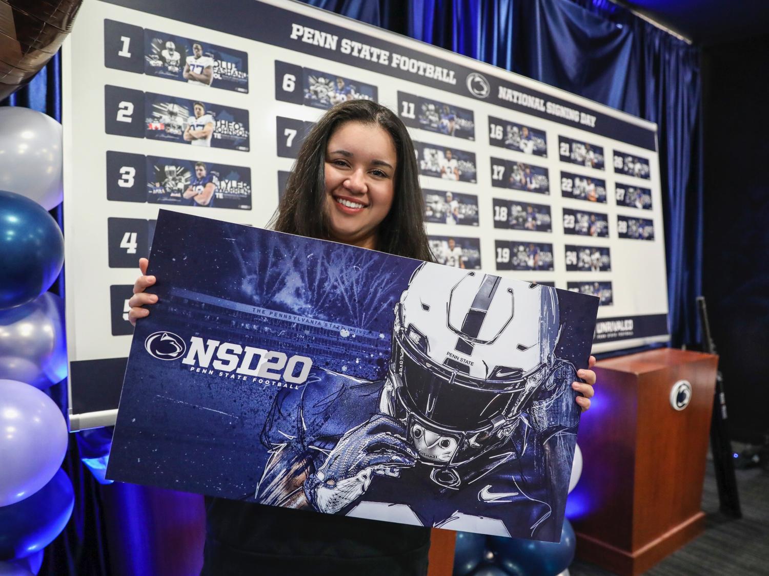 Destiny Rodriguez holding National Signing Day 2020 poster.