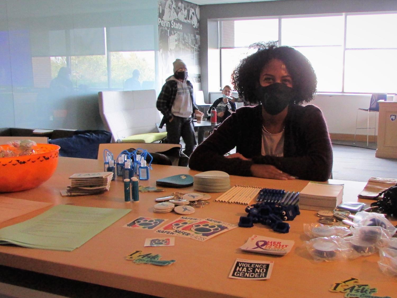 Nuris Perdomo mans a table with information and takeaway items at the Domestic Violence awareness event at Penn State Scranton.