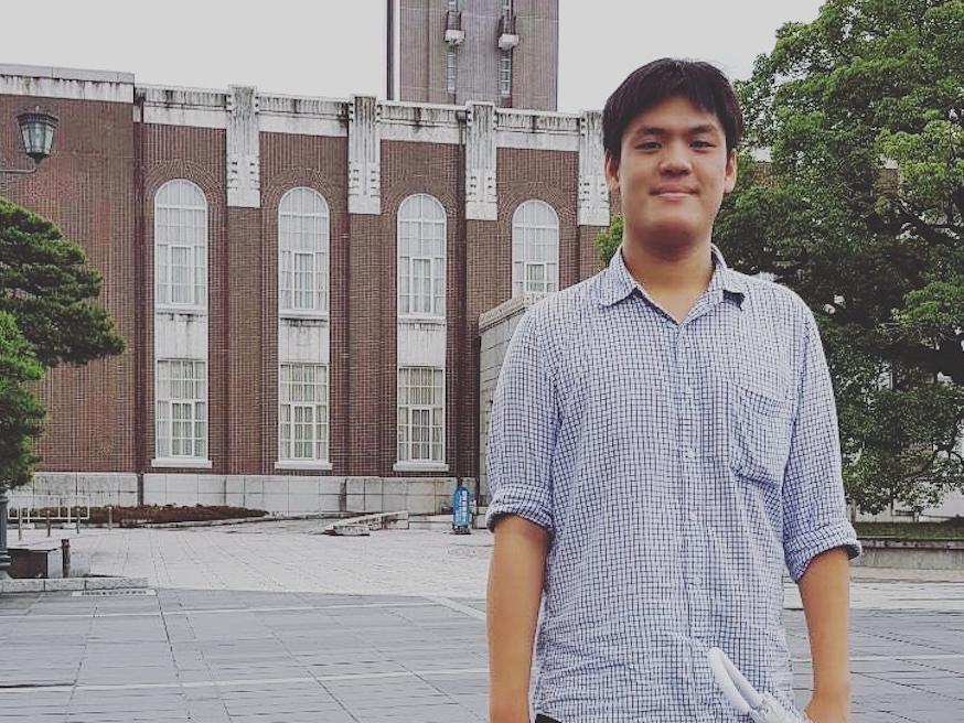 Student standing in a courtyard at Kyoto University in Japan