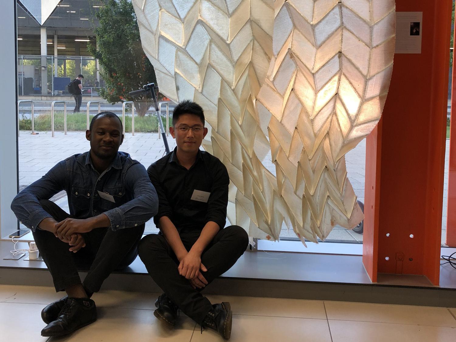 Landscape architecture alums Jimi Demi-Ajayi and Julian Huang in front of their “Phototropic Origami Structure” project at the Textile Intersections conference in London. 